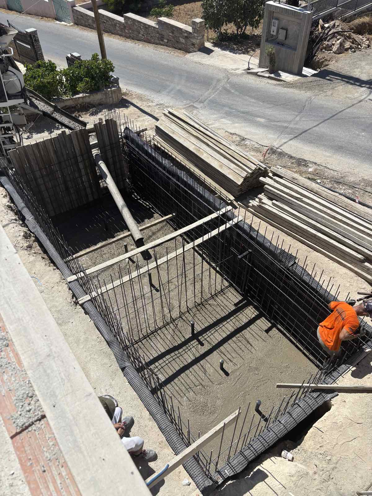 The two pools of Navium Suites begin to take shape at Azolimnos, Syros, July 2026.